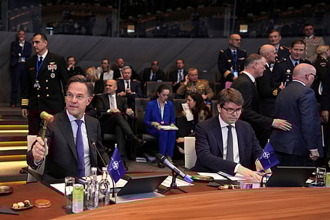 NATO Secretary General Mark Rutte, left, bangs a gavel to signify the start of a meeting of NATO defense ministers at NATO headquarters in Brussels, Thursday, June 5, 2025.