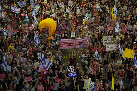 People take part in a protest demanding the end of the war and immediate release of hostages held by Hamas in the Gaza Strip, and against Prime Minister Benjamin Netanyahu's government in Tel Aviv, Saturday, May 31, 2025.