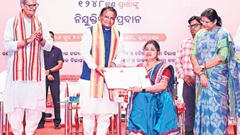 Chief Minister Mohan Charan Majhi handing over appointment letter to a newly-recruited official