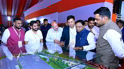 Odisha Chief Minister Mohan Charan Majhi inspects the designs and plans of various industrial projects during his visit to the Gopalpur Tata SEZ, in Ganjam on Thursday.
