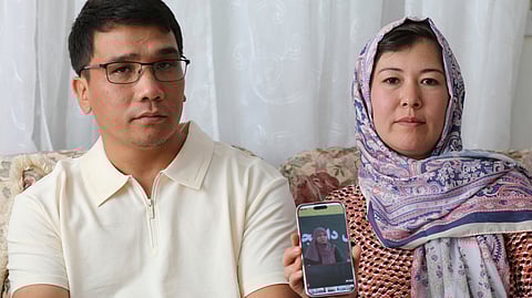 Mohammad Sharafoddin, left, and his wife, Nuriya, right, show a photo of their niece in Afghanistan, who won't be able to travel to the US, under the new travel ban, during an interview at their home in Irmo, S.C., on Saturday, June 7, 2025.