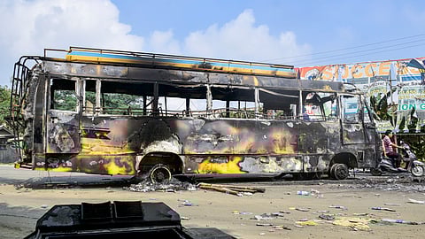 Charred remains of a bus used for transporting central forces, which was set on fire by a mob, a day after protests erupted over the arrest of a leader of Meitei outfit Arambai Tenggol, in Imphal East district, Manipur, Sunday, June 8, 2025.