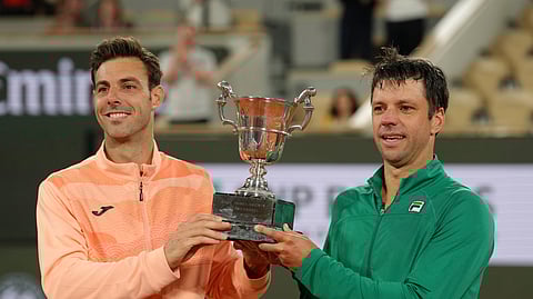 Winners Spain's Marcel Granollers and Argentina's Horacio Zeballos celebrate with the trophy after the men's doubles final match of the French Tennis Open against Britain's Joe Salisbury and Neal Skupski at the Roland-Garros stadium in Paris, Saturday, June 7, 2025.