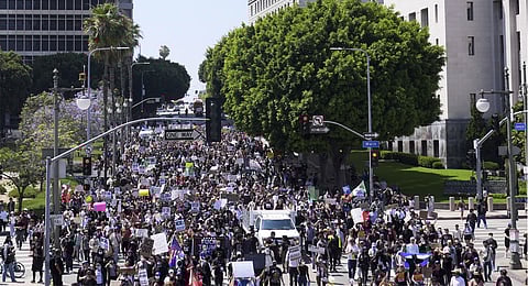 Protesters march from City Hall to the Metropolitan Detention Center in downtown Los Angeles, Sunday, June 8, 2025, following last night's immigration raid protest.