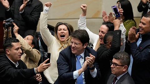 Miguel Uribe Turbay, center in blue tie, a Colombian senator and presidential candidate for the right-wing Centro Democrático party, celebrates after voting against a labor reform referendum proposed by the government, in Bogota, Colombia, May 14, 2025.