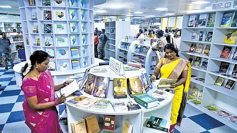 Vistors scan through the books at the book park at Chennai Central Metro station.