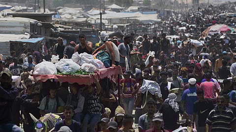 Palestinians carry bags containing food and humanitarian aid packages delivered by the Gaza Humanitarian Foundation, a U.S.-backed organization, in Rafah, southern Gaza Strip, Tuesday, June 10, 2025