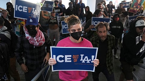 Protesters gather at the US Department of Justice Federal Bureau of Prisons after federal immigration authorities conducted an operation on Friday, June 6, 2025, in Los Angeles.