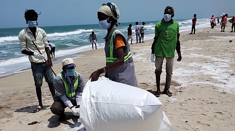 Sanitation workers clearing the plastic nurdles that had washed ashore near Dhanushkodi in Rameswaram on Tuesday.