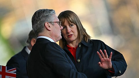 Britain's Prime Minister Keir Starmer (L) in conversation with Chancellor of the Exchequer Rachel Reeves (R) at the Horse Guards Parade in London on May 8, 2025.