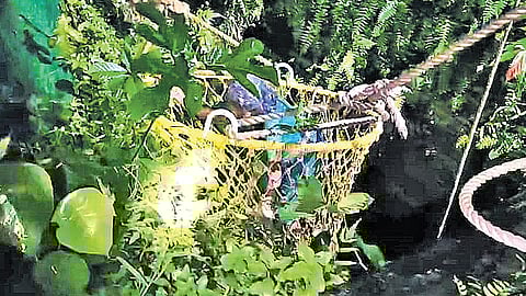 The elderly woman being rescued by the fire force team in Pathanamthitta.