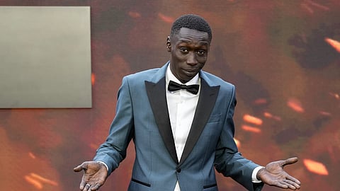 Khaby Lame poses for photographers upon arrival at the premiere of the film "Oppenheimer" in London, July 13, 2025.