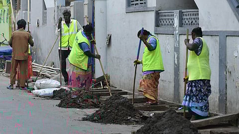 VMC sanitation worker remove silt accumulated in drains near food junction signal in Vijayawada. image used for representational purposes.