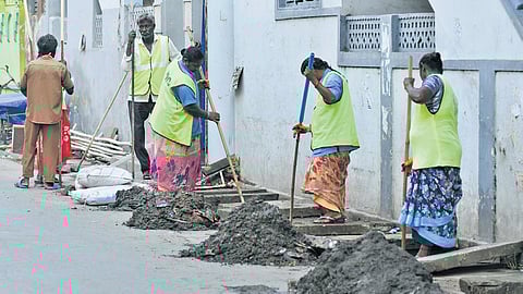 VMC sanitation workers remove silt accumulated in drains in Vijayawada on Thursday
