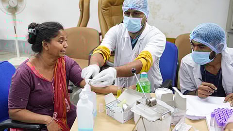 A relative of Air India plane crash victim gives her DNA sample for identification of bodies at a hospital, in Ahmedabad, Friday, June 13, 2025.