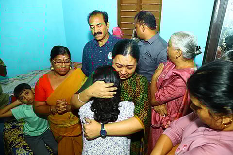 Minister Veena George consoles the daughter of Ranjitha G
Nair during a visit to the latter's home in Pullad, Pathanamthitta