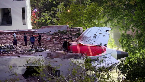 Remains of the Air India plane that crashed moments after taking off from the Ahmedabad airport, lies on a building in Ahmedabad, Thursday, June 12, 2025.