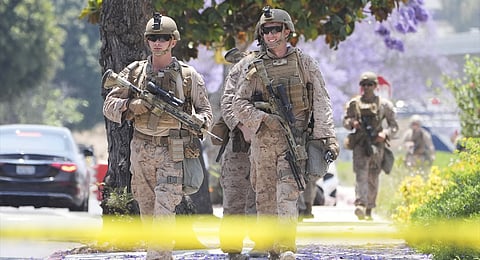 U.S Marines work outside of a federal building, Friday, June 13, 2025, in Los Angeles