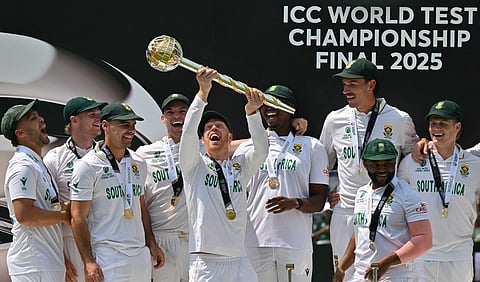 South Africa's wicket keeper Kyle Verreynne, who hit the winning run, lifts up the ICC World Test Championship Mace as he celebrates with teammates after victory on day four of the ICC WTC cricket final match.