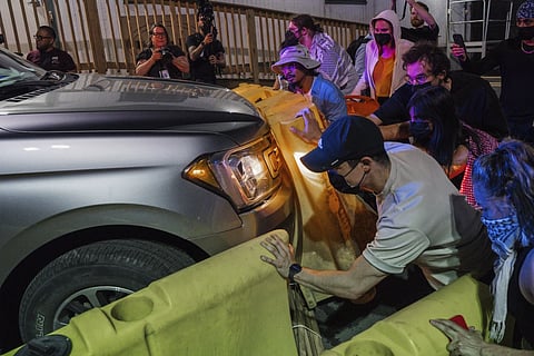 Protesters attempt to block a vehicle from leaving the Delaney Hall Detention Facility during protests over federal immigration enforcement raids on Thursday, June 12, 2025, in Newark, N.J.
