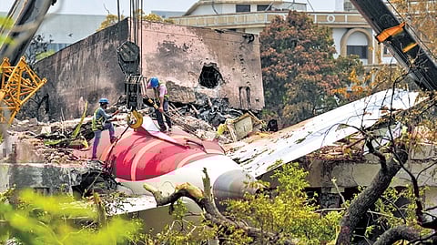 Cranes clearing the debris of the crashed Air India plane in Ahmedabad.