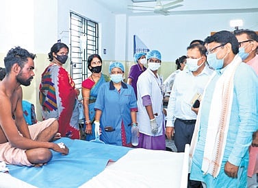 Health Minister Mukesh Mahaling interacts with a patient at Jajpur DHH.