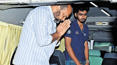 Industries Minister P Rajeeve pays last respects to the deceased inside the ambulance at Kochi airport on Sunday