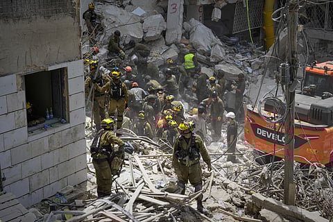 Israeli soldiers search for survivors amid the rubble of residential buildings destroyed by an Iranian missile strike in Bat Yam, central Israel, on Sunday, June 15, 2025.