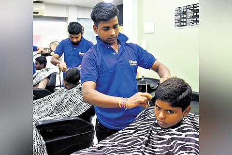 A government school student being given a slick haircut at Thanigaivel’s Dhanush Salon in Adyar, Chennai