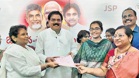 Ponnekkanti Suvarchala Sashikiran and her family members handing over land documents to Civil Supplies Minister Nadendla Manohar on Monday.