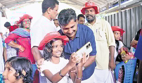 M Swaraj clicks a selfie with a child at an LDF stopover.