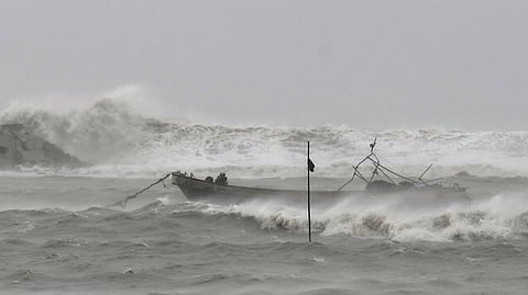 A fishing boat is moored to take shelter from Typhoon Wutip in the waters near a waterfront square in Yinggehai Town, Ledong Li Autonomous County, south China's Hainan Province, on Friday, June 13, 2025.
