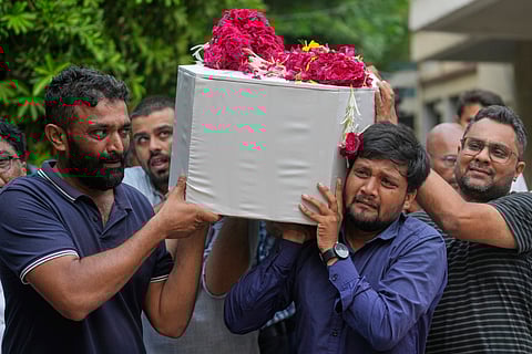 Relatives and neighbors carry the coffin containing the remains of Rozar David Christian, a victim of the Air India plane crash, outside his home in Ahmedabad, India, Sunday, June 15, 2025.