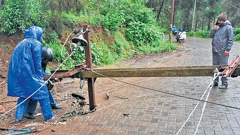 The EB staff fixing damaged electric cables & poles at Fern Hill on Monday