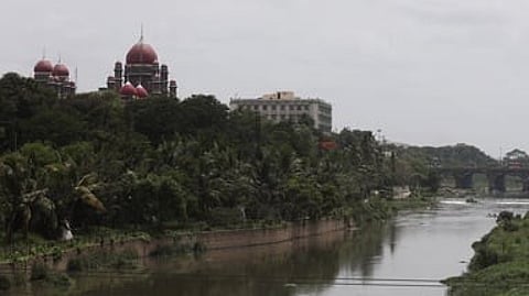 A scenic view of Musi river and Telangana High Court from Afzal Gunj in Hyderabad.