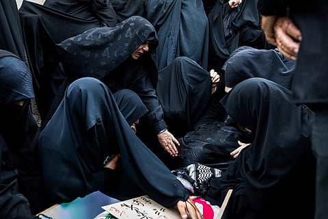 Family members mourn over the body of Mohammadi Javad Naseri, who was killed in Israeli strikes in the northwestern Iranian city of Tabriz, Monday, June 16, 2025.