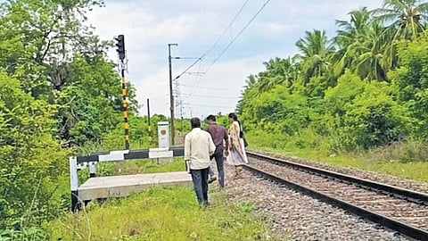 Railway officials inspecting the spot near Magudanchavadi; (bottom) the iron rod used for derailing.