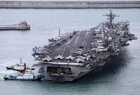The USS Carl Vinson aircraft carrier is escorted into a navy port in Busan, South Korea, March 2, 2025.