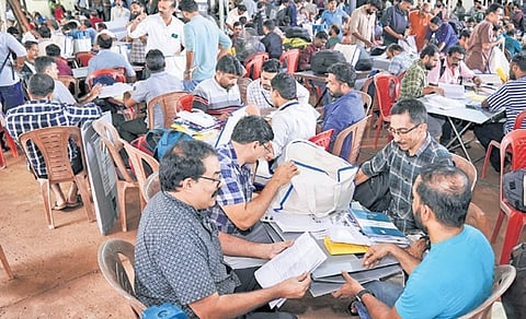 Officials receive electoral material at Chungathara Mar Thoma HSS in Malappuram on Wednesday, the eve of the Nilambur assembly bypoll