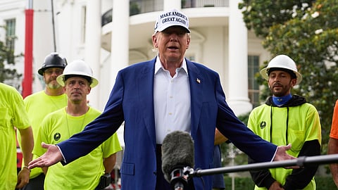 President Donald Trump speaks with reporters before a flag pole is installed on the South Lawn of the White House, Wednesday, June 18, 2025, in Washington.