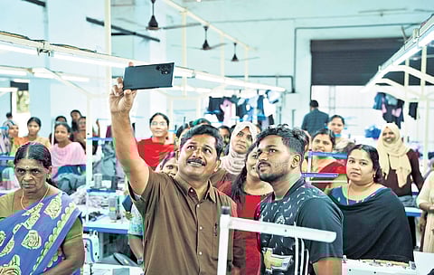 LDF candidate M Swaraj with workers of a factory in Nilambur on Wednesday