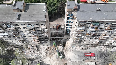 In this aerial photo provided by the Ukrainian Emergency Service, searchers sift through the wreckage at the site of Russia's Tuesday deadly missile attack that ruined a multistory residential building in Kyiv, Ukraine, Wednesday, June 18, 2025.