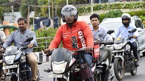 A food delivery person travelling in a two-wheeler in Tiruchy on Wednesday.