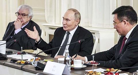 TASS news agency First Deputy Director General Mikhail Gusman, left, and Xinhua News Agency President Fu Hua, right, attend a meeting of Russian President Vladimir Putin, center, with the heads of international news agencies at the newly renovated St. Petersburg Rimsky-Korsakov State Conservatory on the sidelines of the St. Petersburg International Economic Forum in St. Petersburg, Russia, Thursday, June 19, 2025.