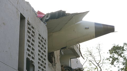 The debris of the Air India AI171 airplane sticks out of a building after it crashed in Ahmedabad, Gujarat, Thursday, June 12, 2025.