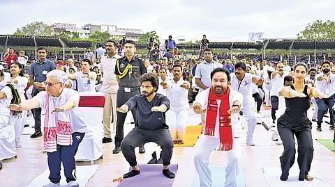 Union Minister G Kishan Reddy, along with Governor Jishnu Dev Varma, participates in a yoga programme ahead of the International Yoga Day in Hyderabad on Friday.