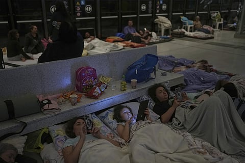 People take shelter in an underground metro station as a precaution against possible Iranian missile attacks, in Ramat Gan, near Tel Aviv, Israel, Tuesday, June 17, 2025.