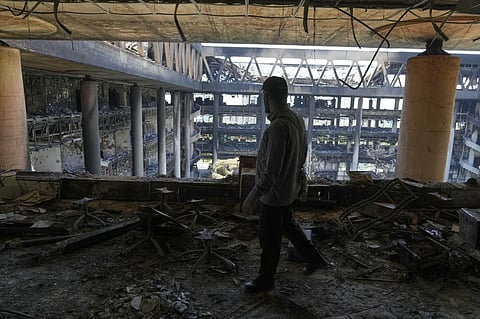 A man walks in the damaged headquarters of Islamic Republic of Iran Broadcasting, Iranian state television, in Tehran, Iran, Thursday, June 19, 2025.