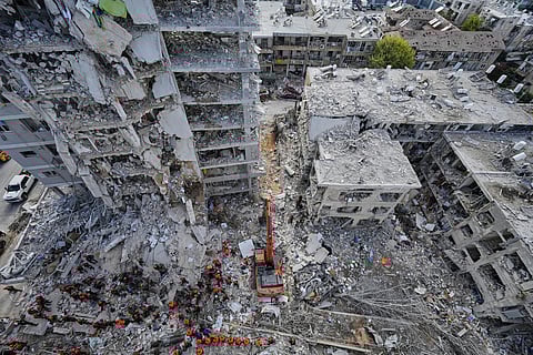 Israeli soldiers search through the rubble of residential buildings destroyed by an Iranian missile strike in Bat Yam, central Israel, on Sunday, June 15, 2025.