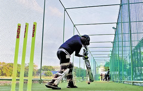 Children practise in the newly installed cricket nets at the Central Stadium in Thiruvananthapuram.